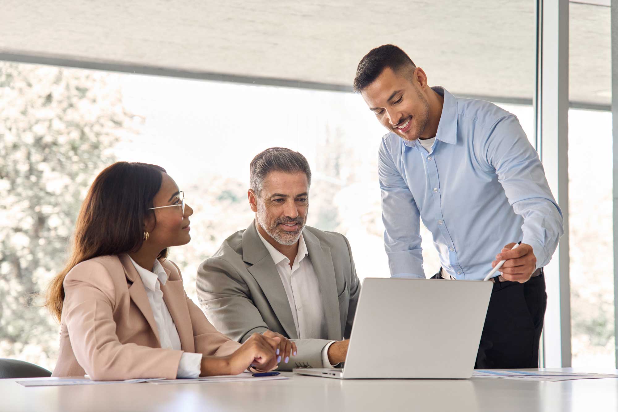 happy-business-people-executive-team-working-at-laptop-using-computer-having-discussion-at-office-professional-meeting-showing-financial-project-results